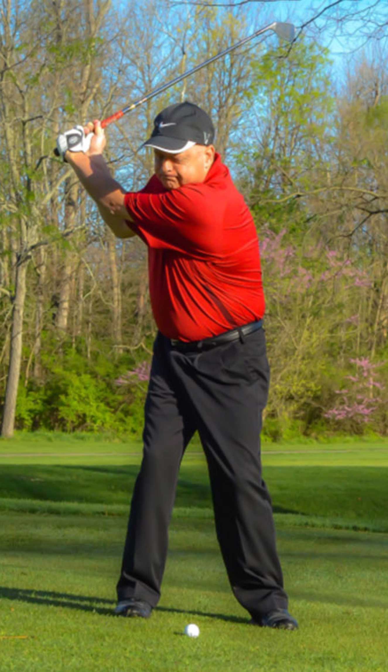 James swinging a golf club